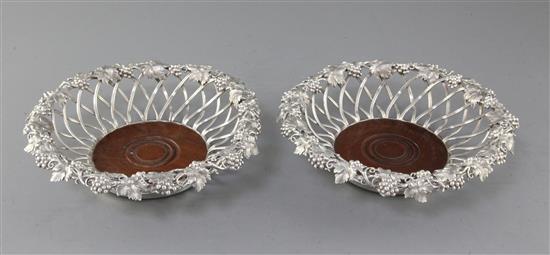 An ornate pair of Victorian silver wirework wine coasters by Edward & John Barnard, 20.7cm.